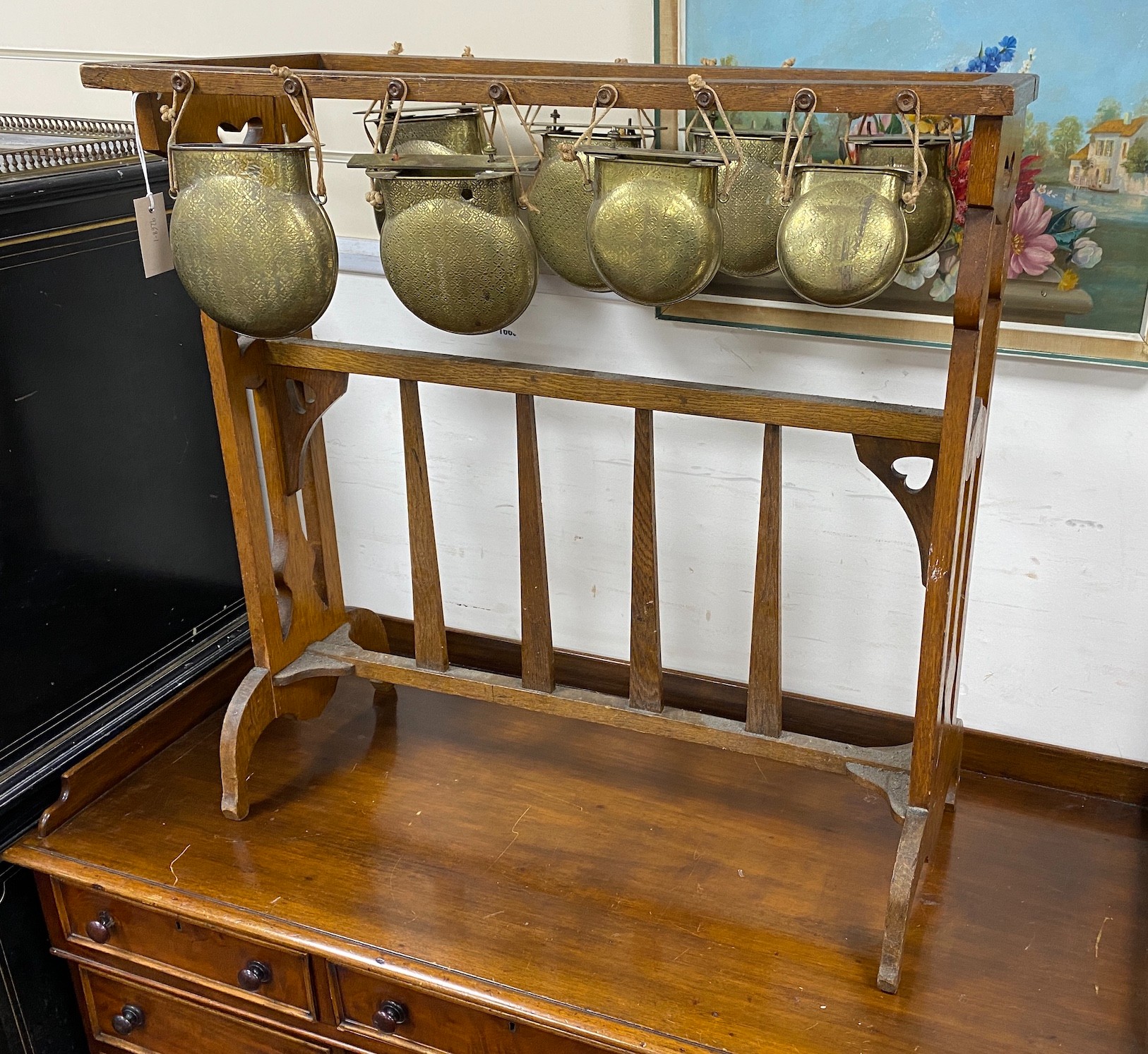 An Arts & Crafts oak and brass Glockenspiel by Plant and Percy, width 78cm, height 79cm
